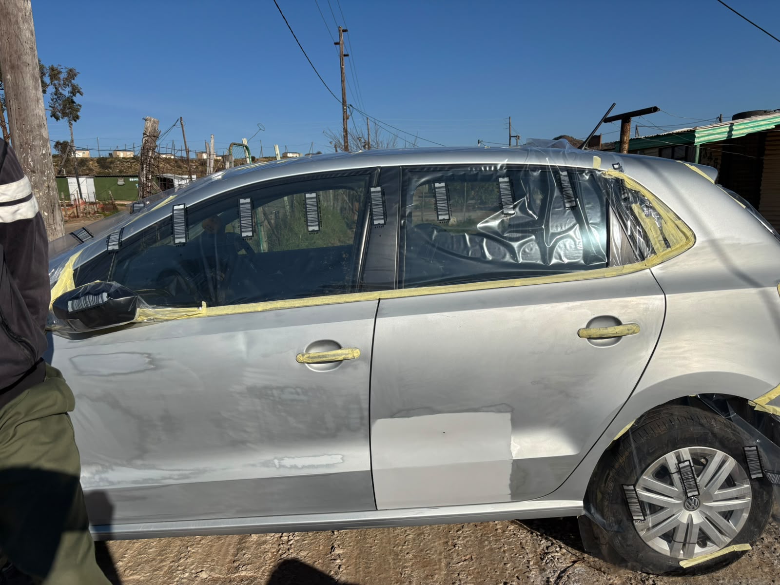 Silver VW Polo masked and prepared for spray painting